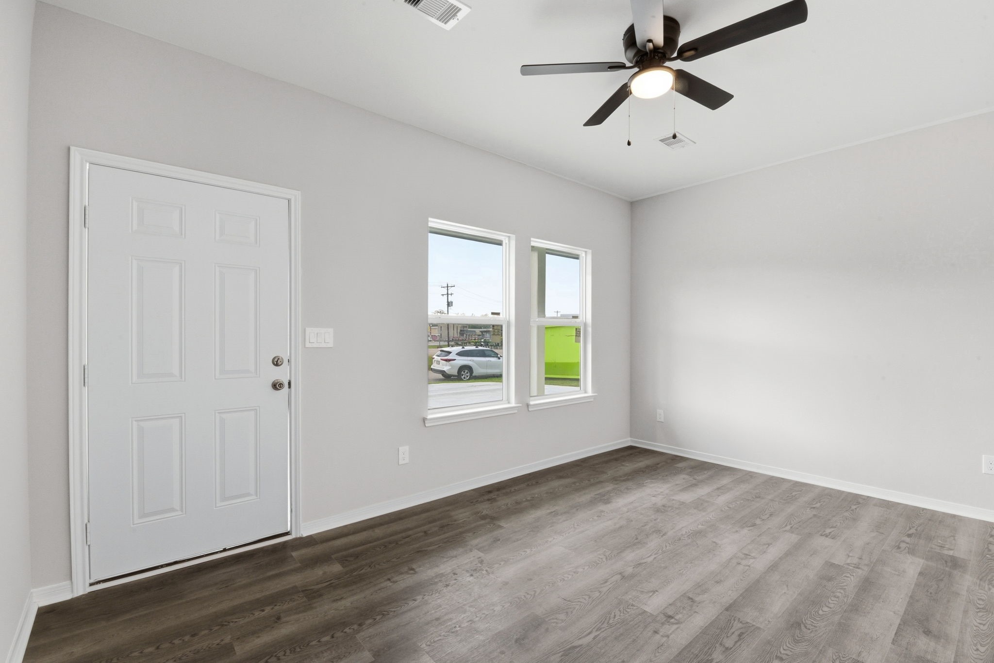 2521 Maple Street, Unit 2521A Liberty, TX 77575 - Photo 5 of 25 wooden floor in an empty room with a window