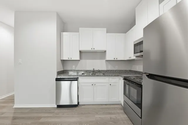 a kitchen with stainless steel appliances granite countertop a stove and a sink