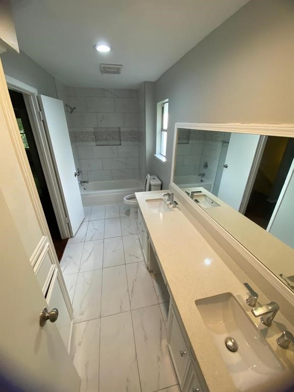 5710 Glenmere Lane Spring, TX 77379 - Photo 2 of 9 a bathroom with a double vanity sink and mirror