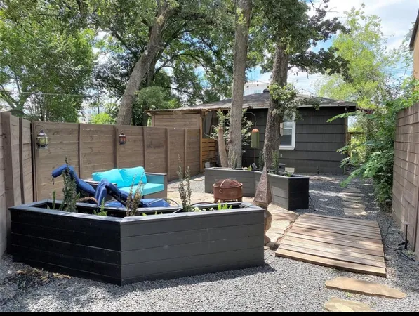 a view of a roof deck with couches and a fire pit