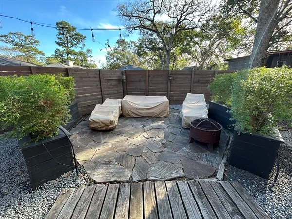 a view of a backyard with sitting area
