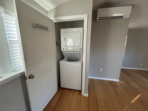 a view of a hallway with wooden floor and closet