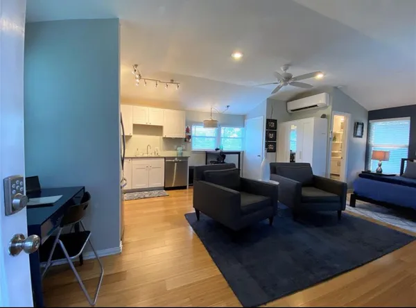 a living room with furniture and a chandelier