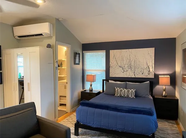 a bedroom with a bed and window