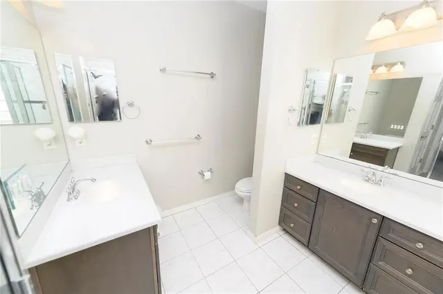 a bathroom with a sink a toilet and mirror