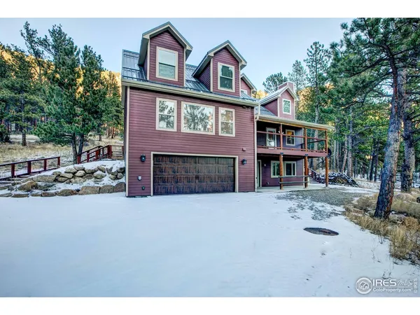 a view of a house with a yard covered in snow