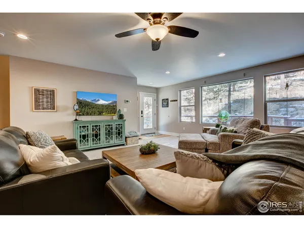 a living room with furniture fireplace and a large window
