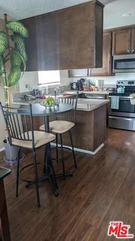 a kitchen with a table chairs stove and cabinets