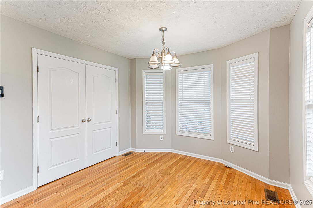 3831 Talus Road Fayetteville, NC 28306 - Photo 15 of 41 a view of a bedroom with wooden floor and windows