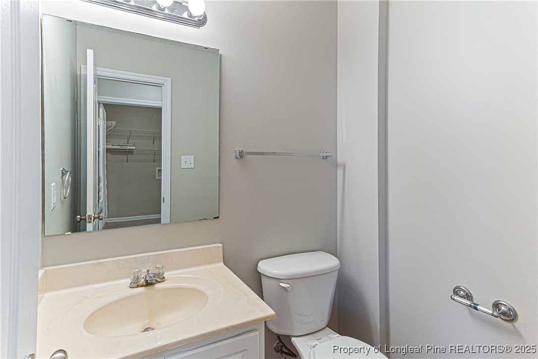 3831 Talus Road Fayetteville, NC 28306 - Photo 17 of 41 a bathroom with a sink a toilet and mirror