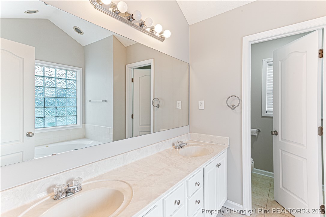 3831 Talus Road Fayetteville, NC 28306 - Photo 21 of 41 a bathroom with a sink double vanity and a mirror