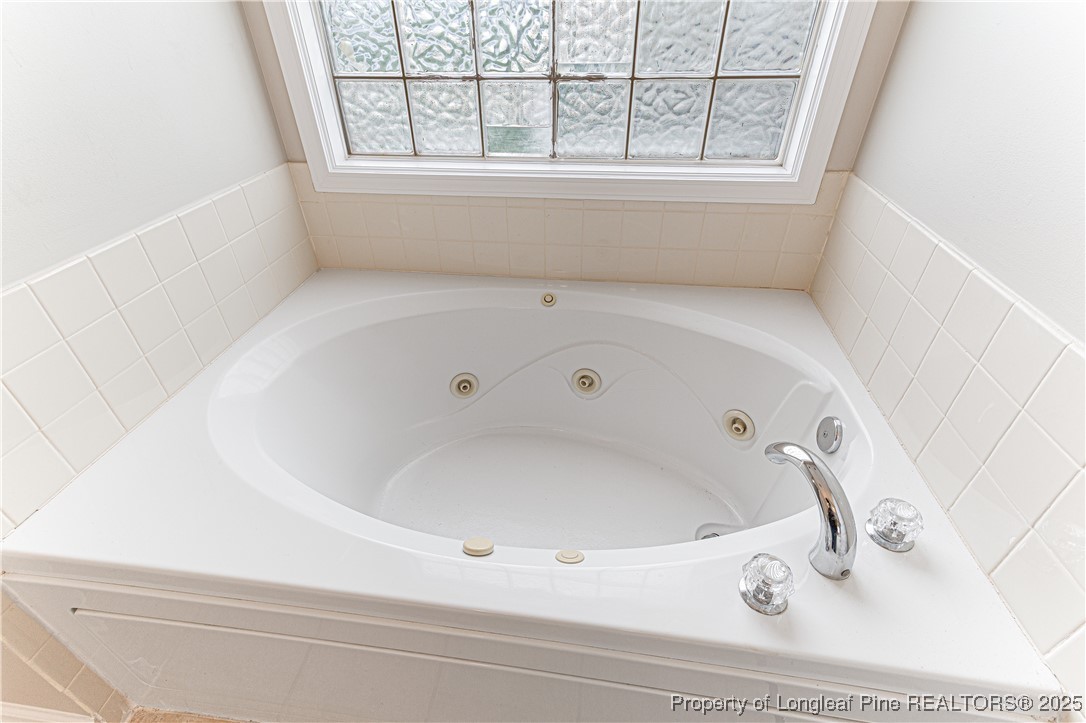 3831 Talus Road Fayetteville, NC 28306 - Photo 22 of 41 a bathroom with bathtub and window
