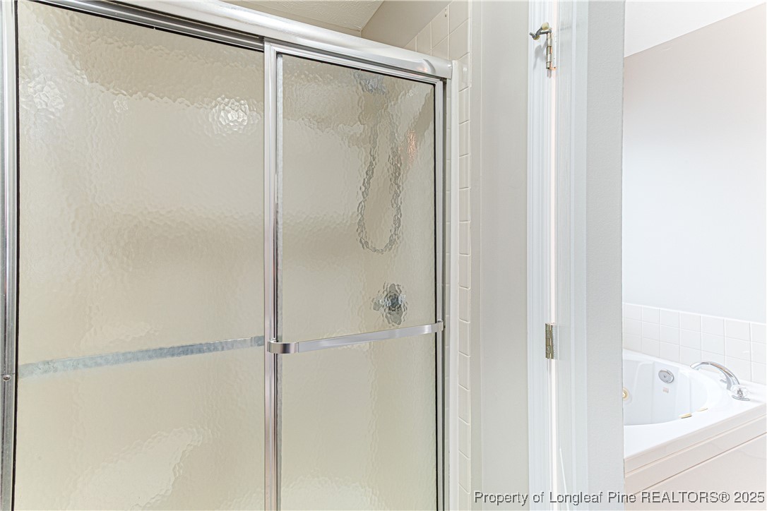 3831 Talus Road Fayetteville, NC 28306 - Photo 23 of 41 a bathroom with a glass shower door