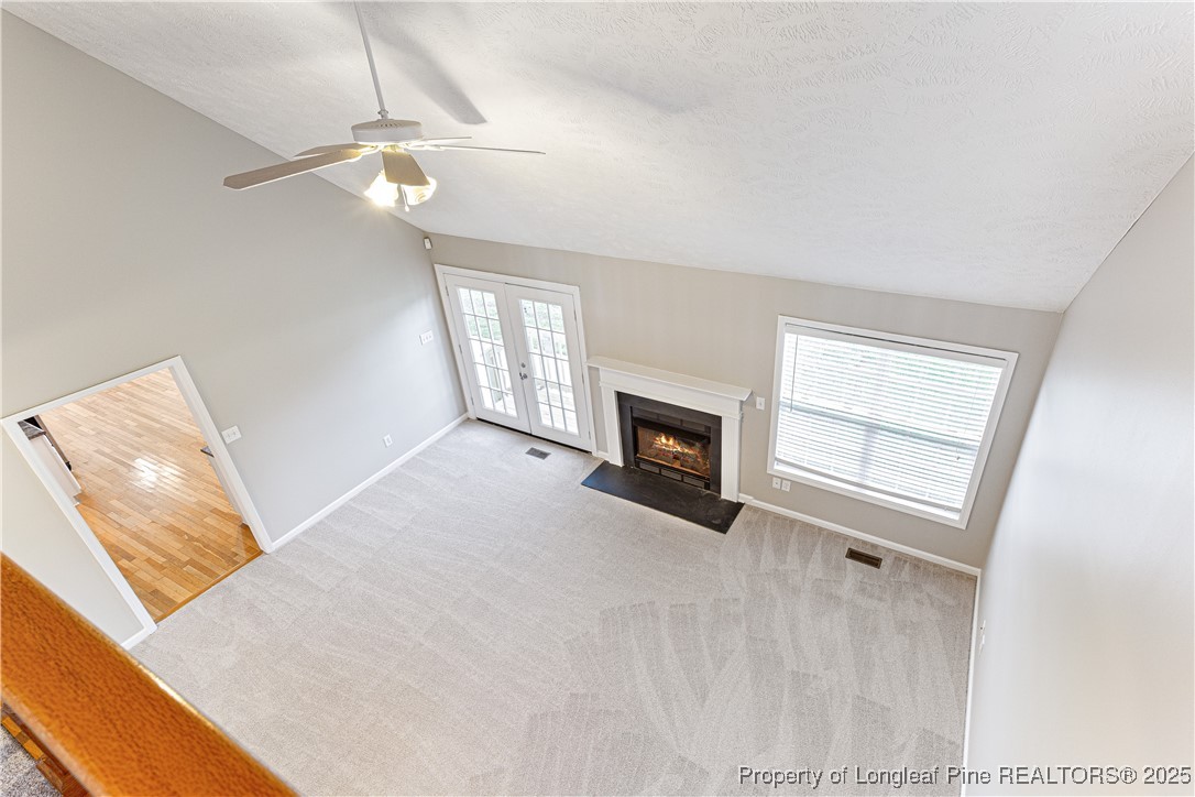 3831 Talus Road Fayetteville, NC 28306 - Photo 25 of 41 a view of an empty room with chandelier fan and fire place