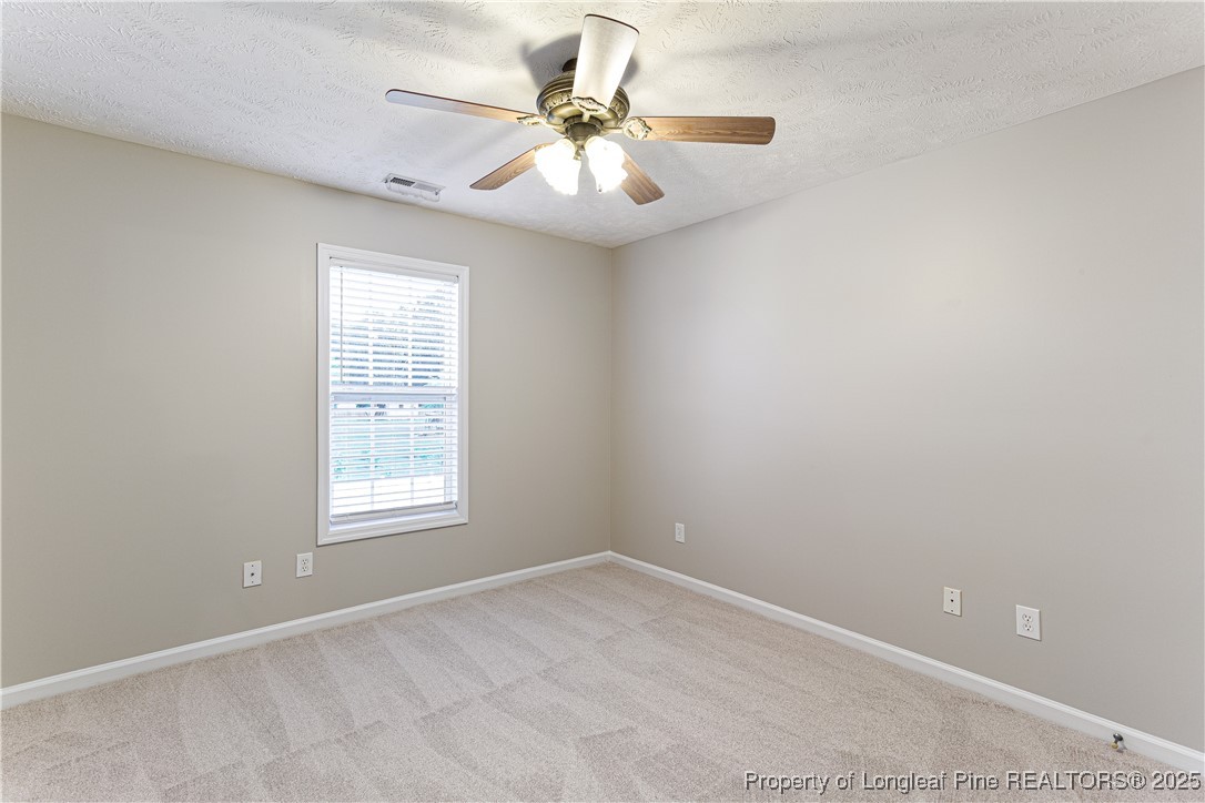 3831 Talus Road Fayetteville, NC 28306 - Photo 28 of 41 an empty room with windows and fan