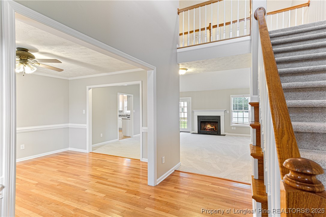 3831 Talus Road Fayetteville, NC 28306 - Photo 5 of 41 a view of a hallway with wooden floor and staircase