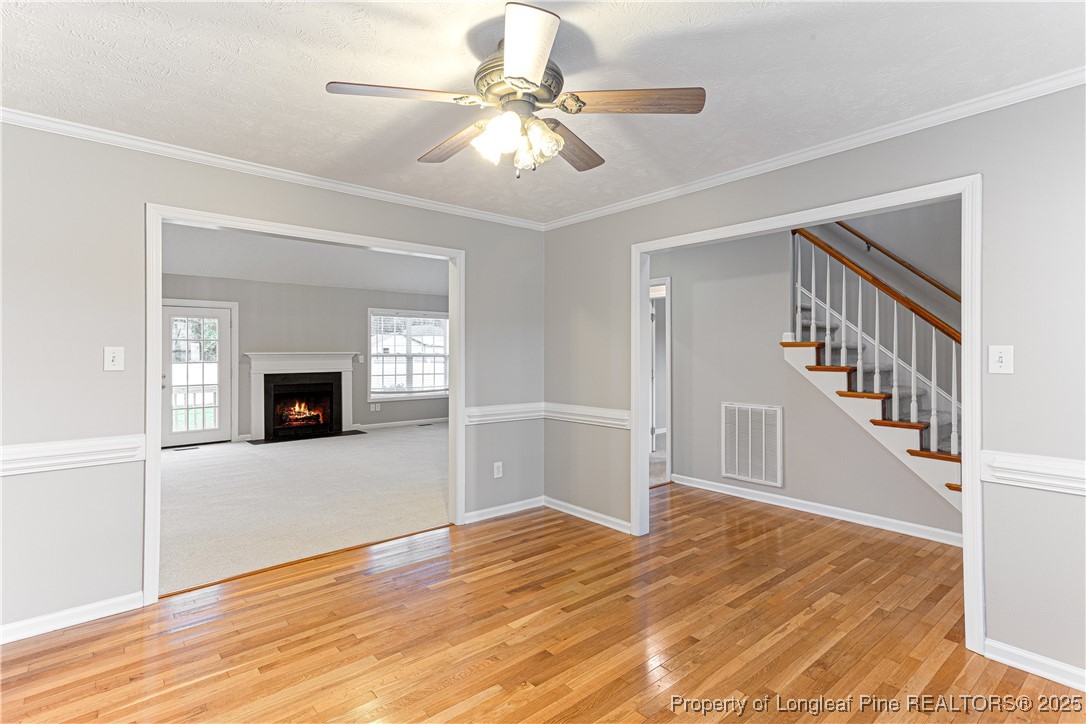 3831 Talus Road Fayetteville, NC 28306 - Photo 7 of 41 a view of a livingroom with wooden floor and a ceiling fan