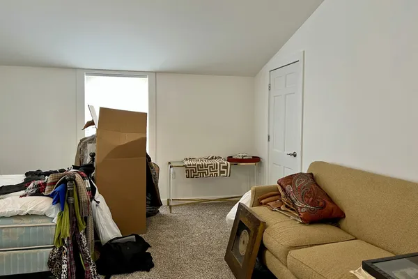 a bedroom with a bed and a chair