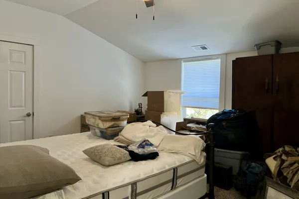 a view of a bedroom with two beds and a couch