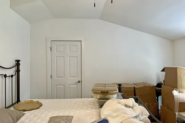 a view of a bedroom with a bed and closet