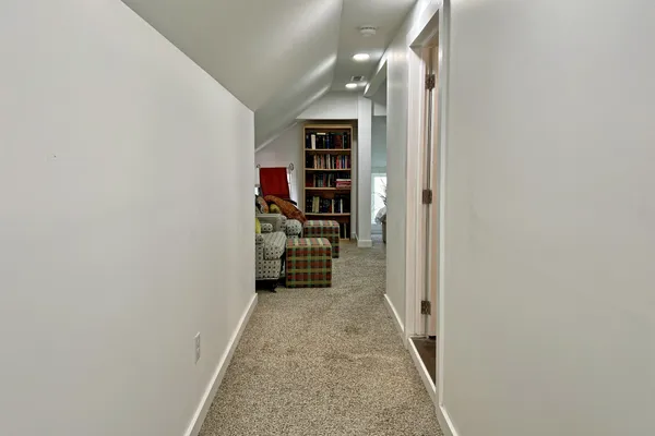 a living room with furniture and a book shelf