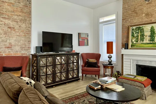 a living room with furniture and a fireplace