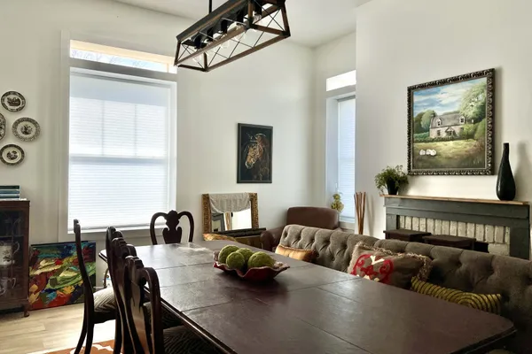 a living room with furniture kitchen view and a window