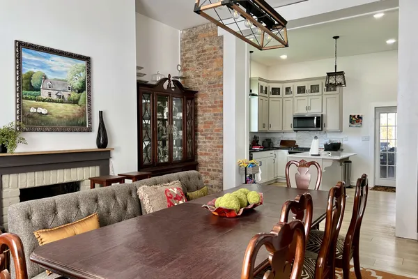 a dining room with furniture a rug and a chandelier