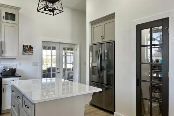 a kitchen with stainless steel appliances granite countertop a sink a stove and a microwave