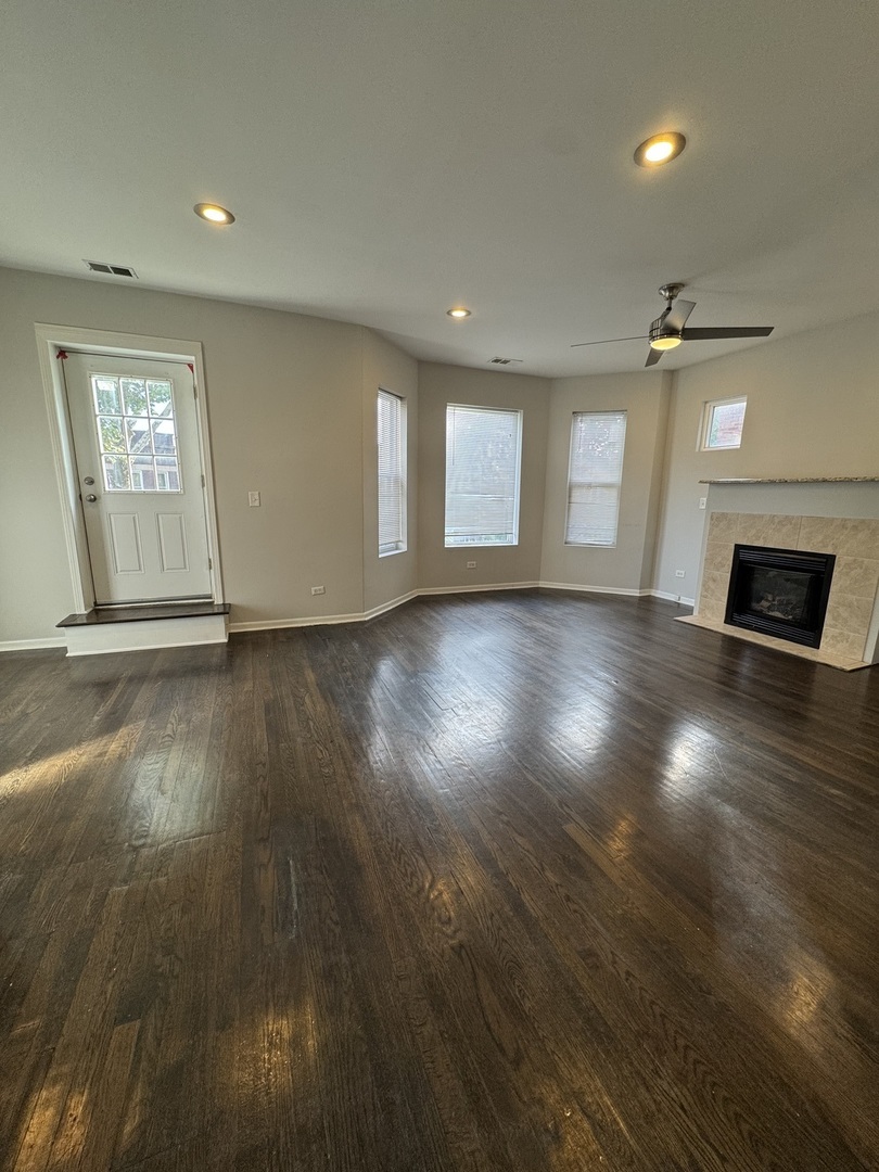 6130 South Rhodes Avenue, Unit 2 Chicago, IL 60637 - Photo 3 of 9 an empty room with wooden floor and windows
