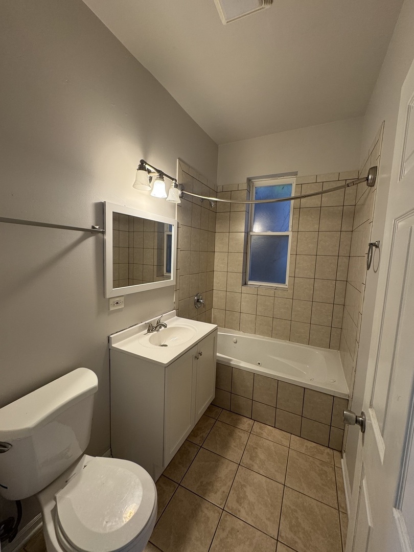6130 South Rhodes Avenue, Unit 2 Chicago, IL 60637 - Photo 8 of 9 a bathroom with a sink toilet tub and shower