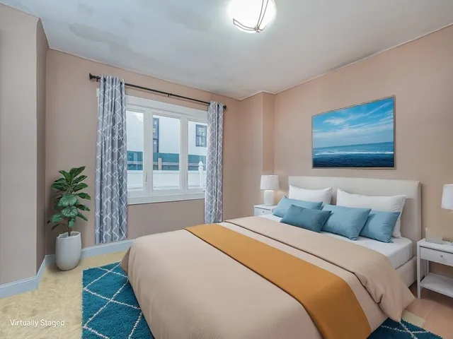 a bedroom with a bed and a potted plant