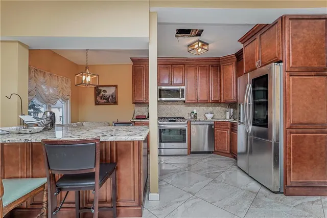 a kitchen with a sink refrigerator and cabinets
