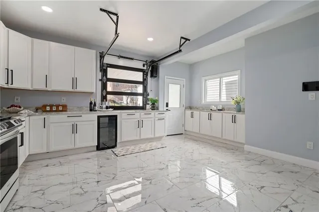 a kitchen with white cabinets and white appliances