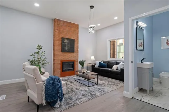 a living room with furniture a fireplace and a flat screen tv