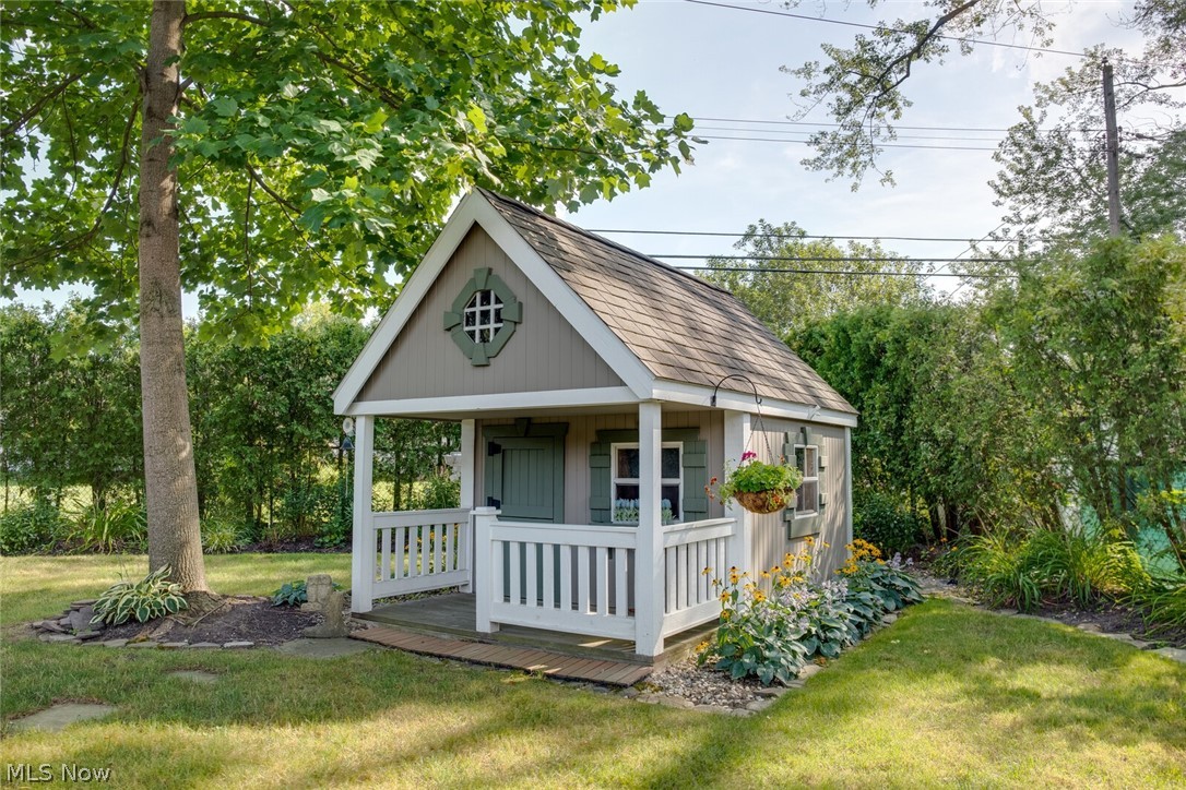 5004 Fairlawn Road Cleveland, OH 44124 - Photo 10 of 27 The custom playhouse shed has a full-size door in the rear, so it can be used as storage. The darling front porch and dutch door lead to a play space with a loft.