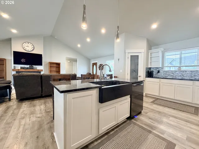 a kitchen with granite countertop a sink and cabinets