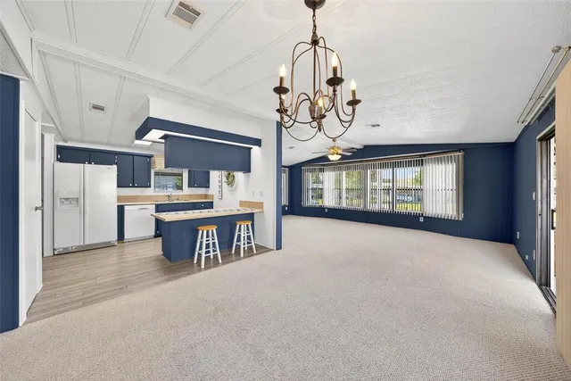 a view of a house with swimming pool and sitting area
