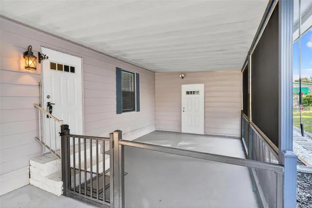 a view of an empty room with a window and fireplace