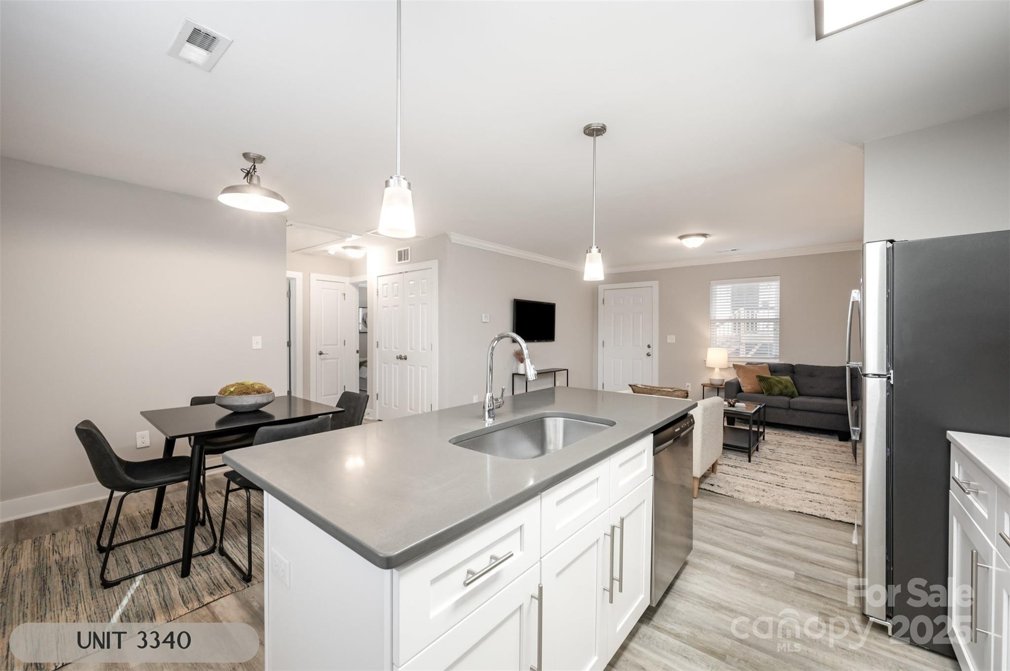3342 Washburn Avenue Charlotte, NC 28205 - Photo 15 of 45 a kitchen with a kitchen island a sink appliances and a counter top space