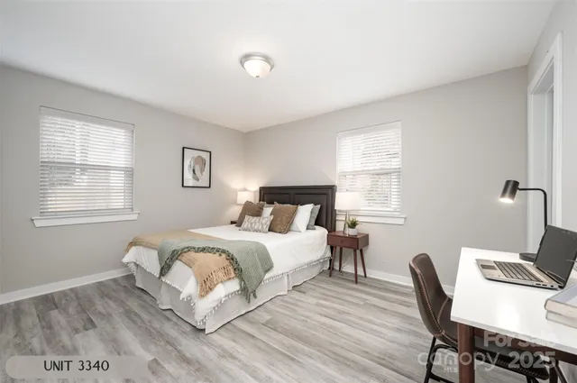 a bedroom with a bed a chair and a window