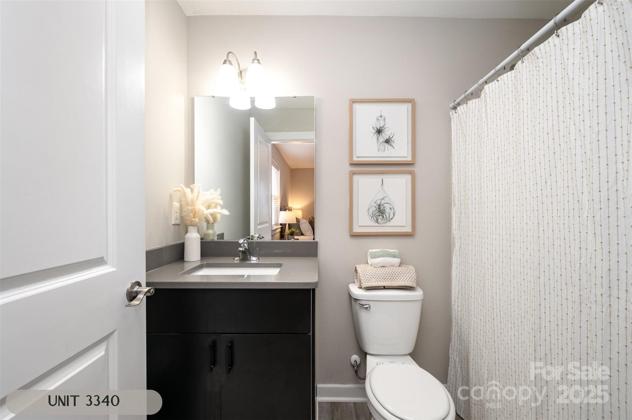 3342 Washburn Avenue Charlotte, NC 28205 - Photo 20 of 45 a bathroom with a toilet sink and mirror