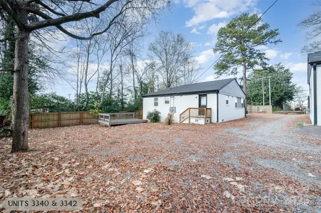 a view of a house with backyard and a tree