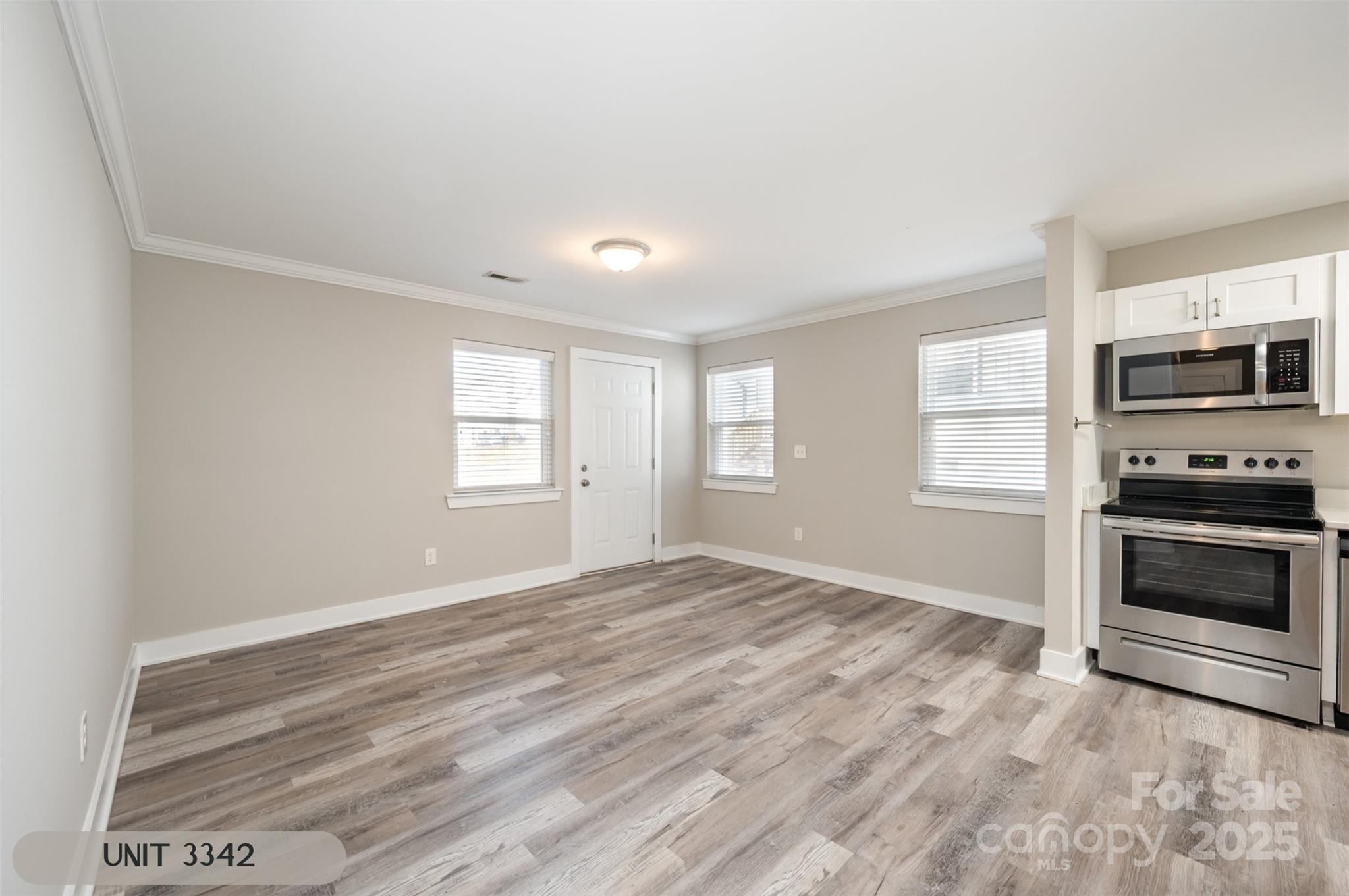 3342 Washburn Avenue Charlotte, NC 28205 - Photo 31 of 45 a view of an empty room with a window and a kitchen