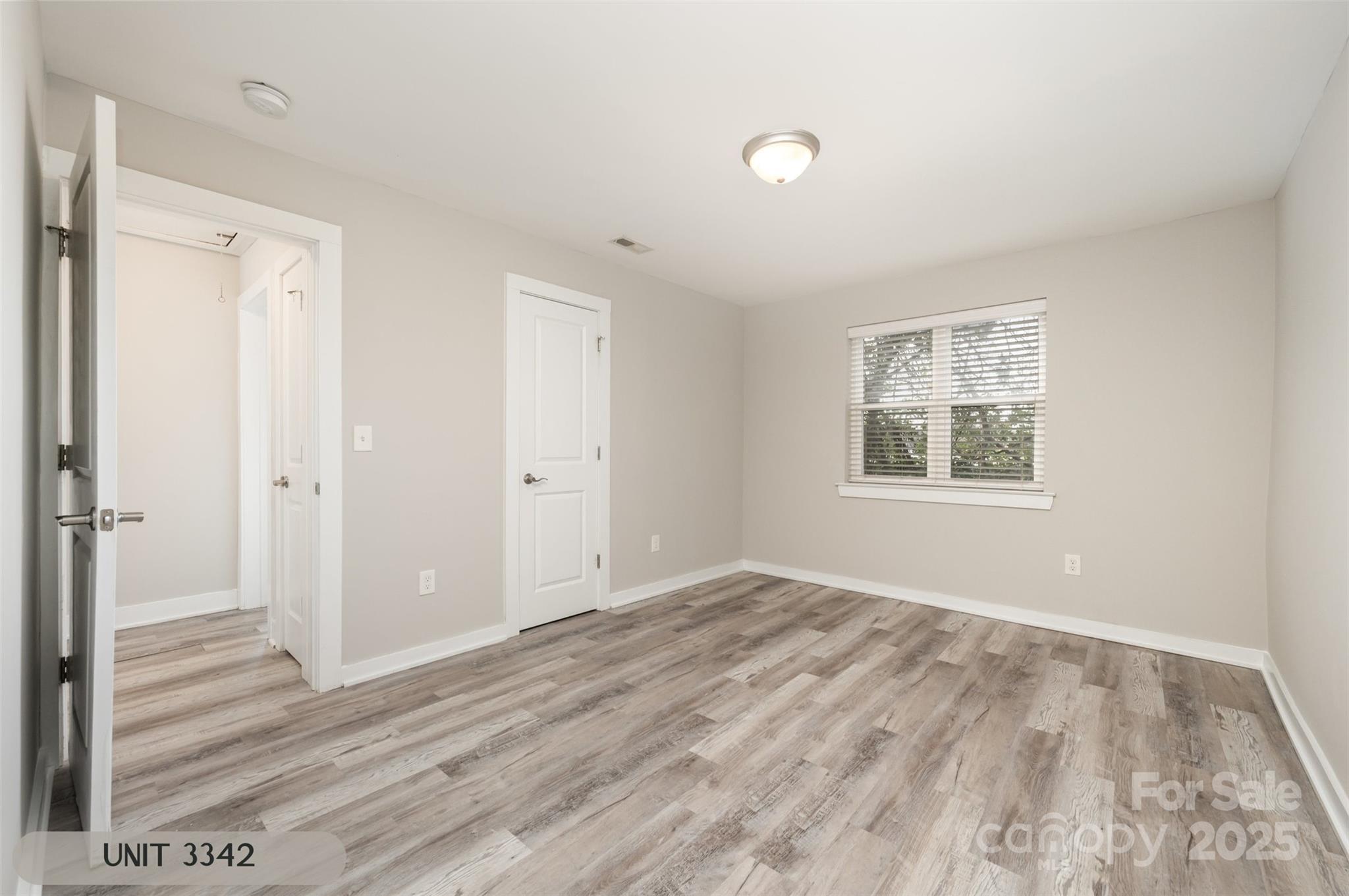 3342 Washburn Avenue Charlotte, NC 28205 - Photo 37 of 45 a view of an empty room with wooden floor and a window