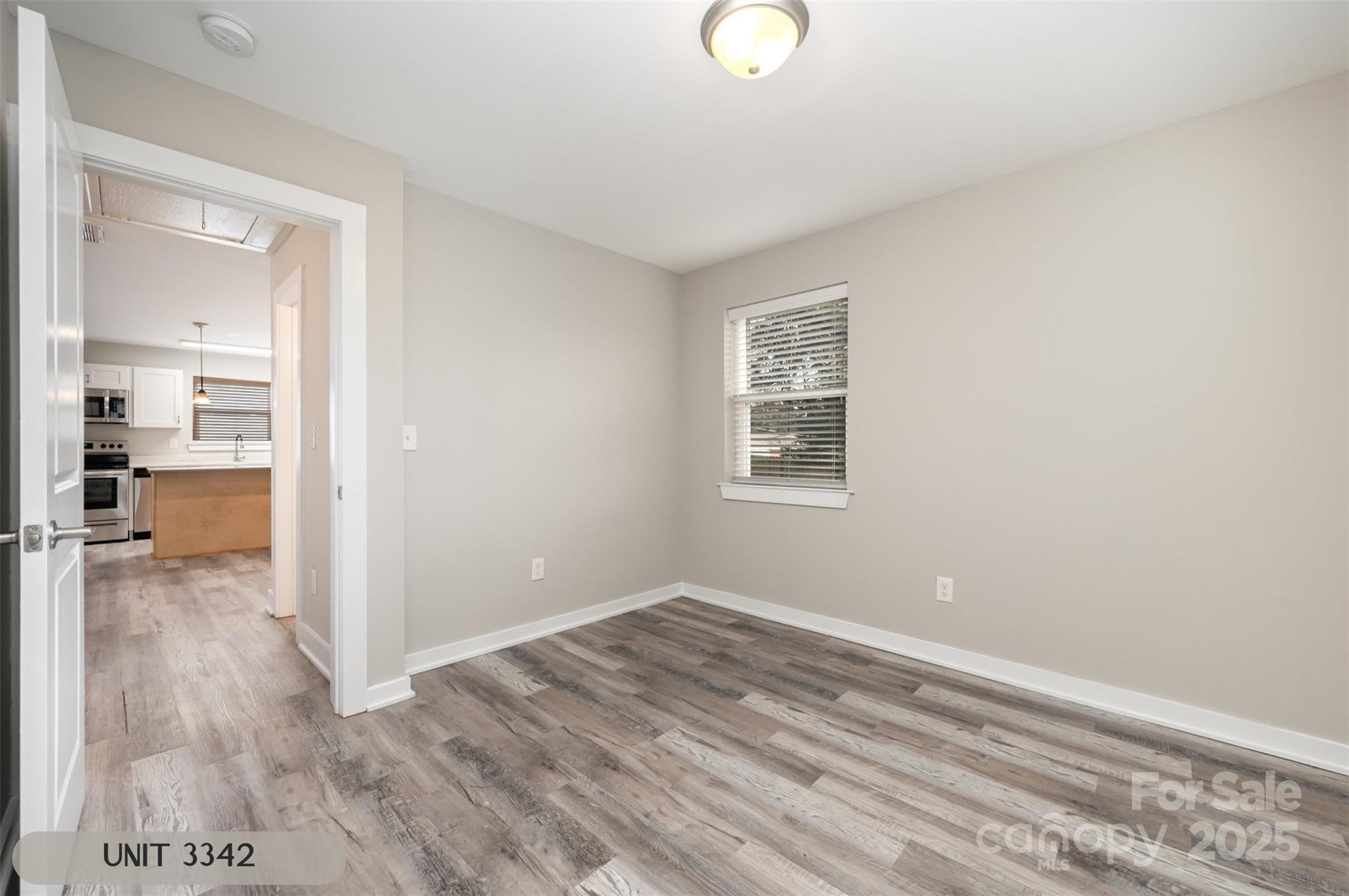 3342 Washburn Avenue Charlotte, NC 28205 - Photo 41 of 45 a view of a room with wooden floor and a large window
