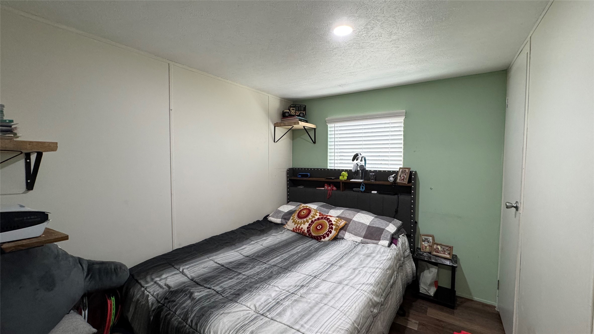 14348 West Ravine Run Willis, TX 77318 - Photo 13 of 15 a bedroom with a bed and wooden floor