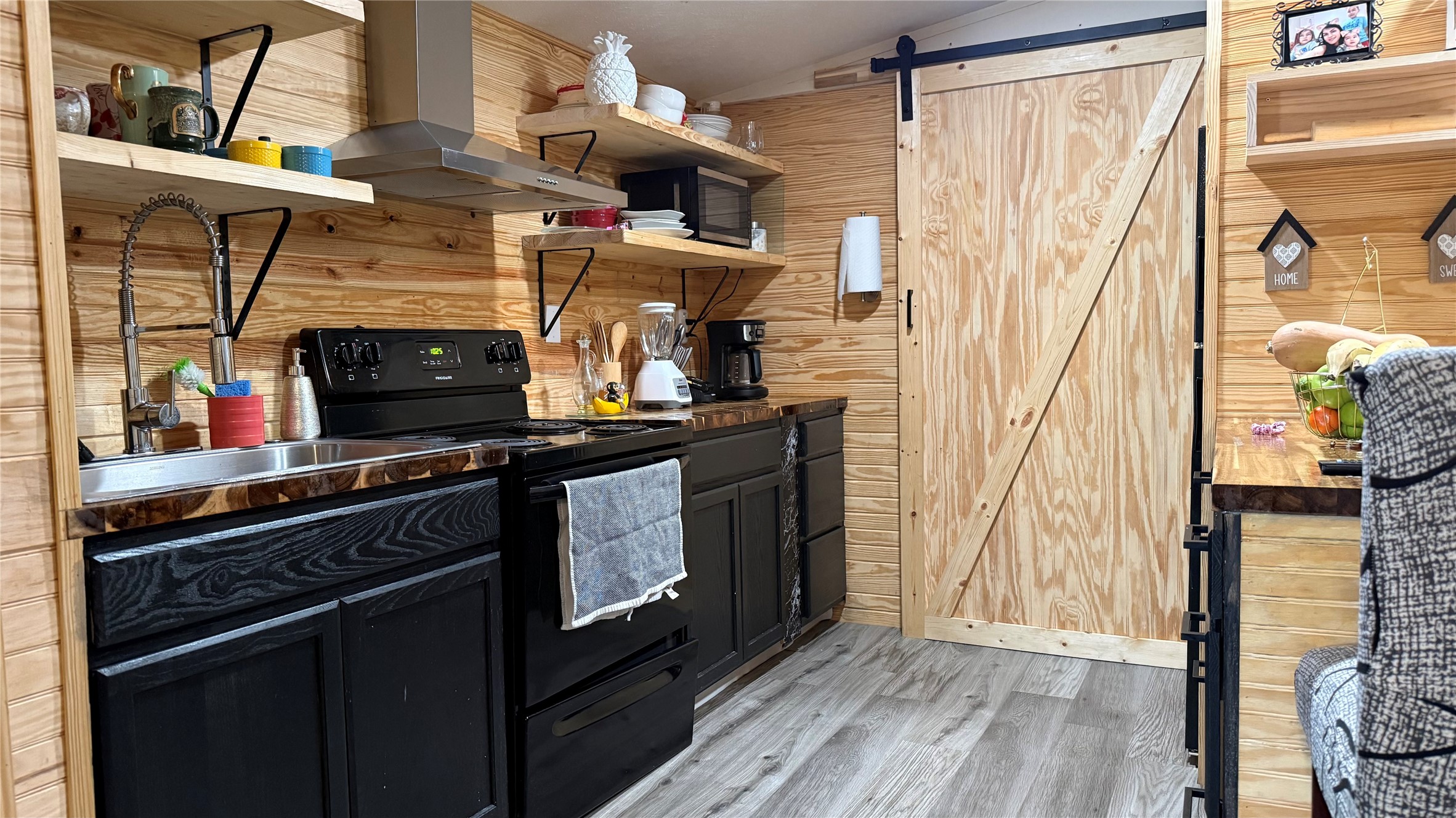 14348 West Ravine Run Willis, TX 77318 - Photo 9 of 15 a kitchen with stainless steel appliances a stove and a wooden floor