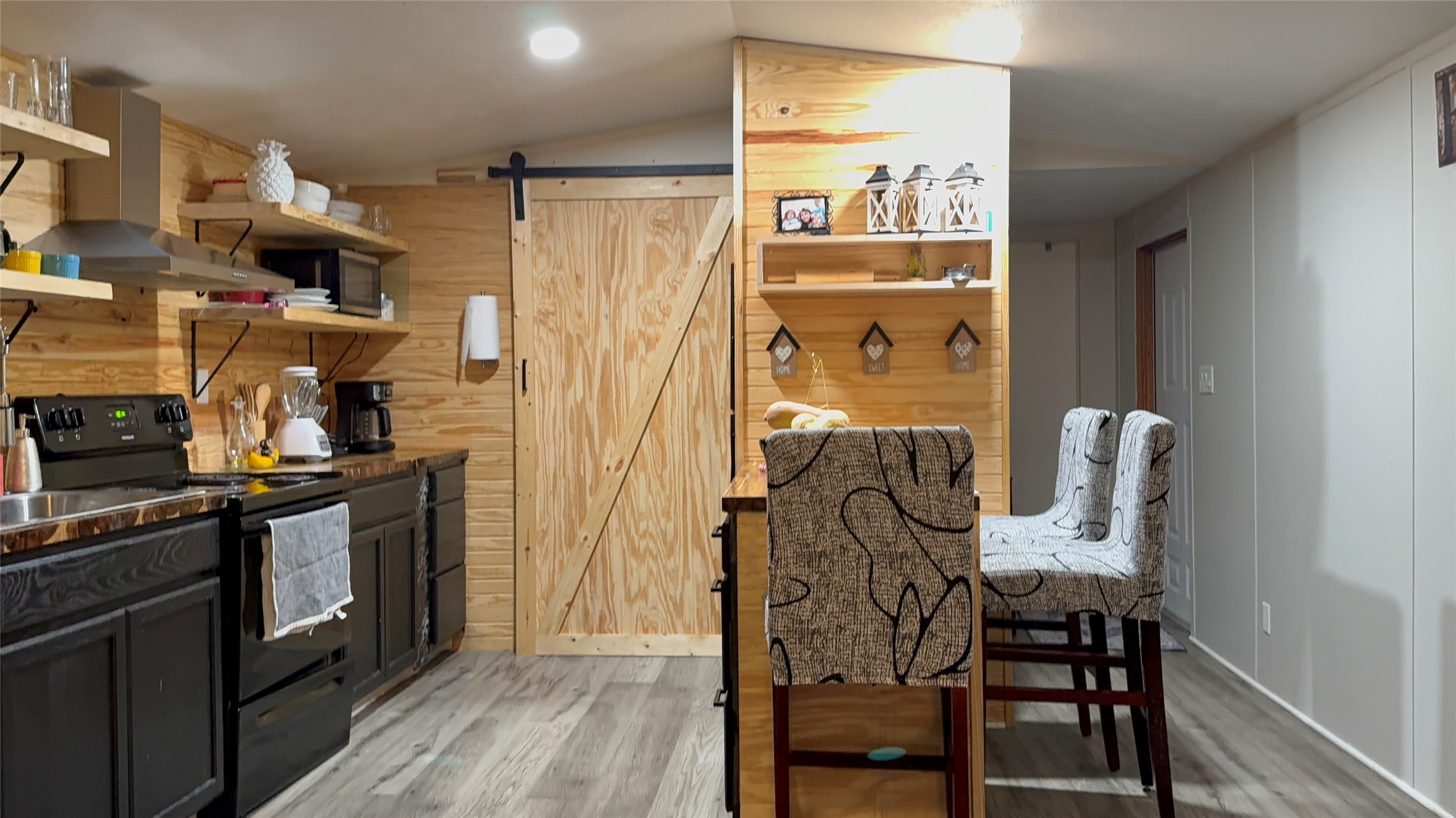 14348 West Ravine Run Willis, TX 77318 - Photo 10 of 15 a view of a dining room with furniture a chandelier and wooden floor