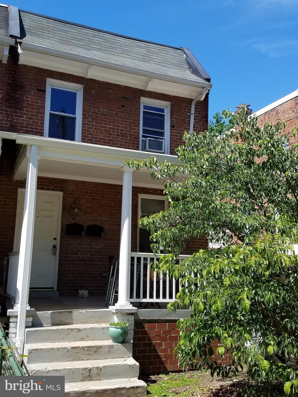 a view of a house with large windows and a small yard